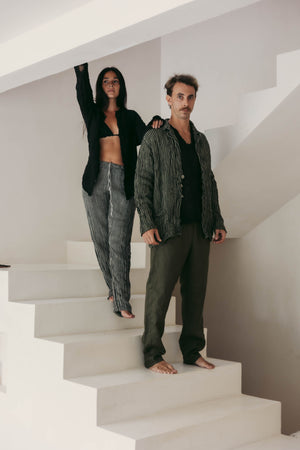 Two people standing on a staircase in a minimalistic setting