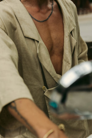 Minimalist khaki linen kimono with clean tailoring and natural texture.
