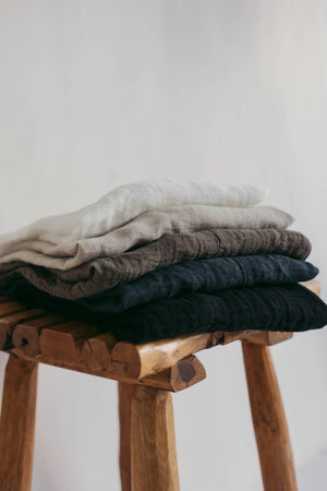 Collarless men's raw linen shirt with full button front.