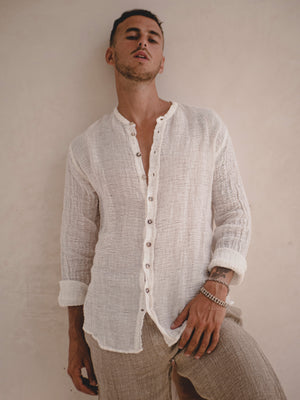 man wearing a Collarless men's raw linen shirt with full button front.