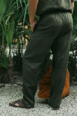 Back view of relaxed fit men's linen pants with an elastic waistband.