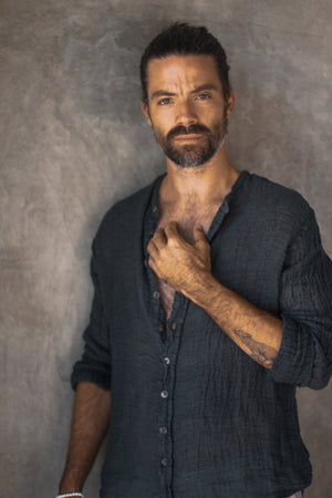 Man wearing the Raw Linen Collarless Shirt crafted from Italian raw linen.