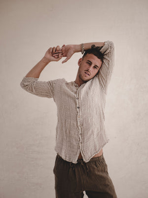 Collarless men's raw linen shirt with full button front.