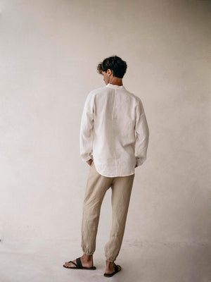 Man wearing a white linen shirt and beige pants