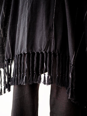 Oversized black cotton cape poncho for men with hand-finished fringe. Lightweight breathable cover up for beachwear, vacations and relaxed resort style.