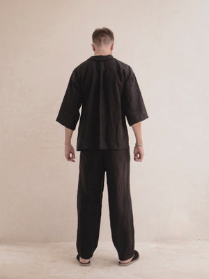 Back view of a men's oversized linen kimono cover up in black.