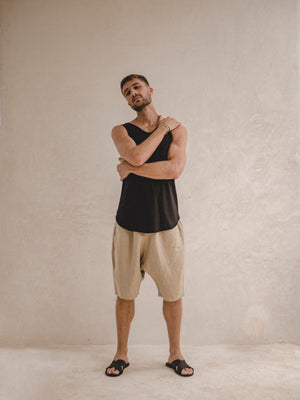 man wearing an oversized linen bermuda in khaki color