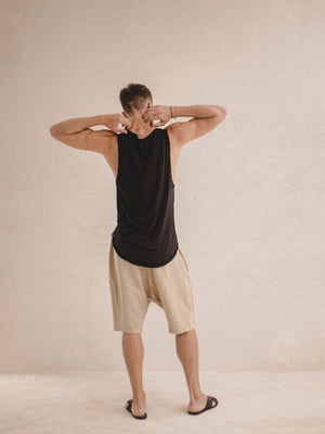 man wearing an oversized linen bermuda short in khaki color