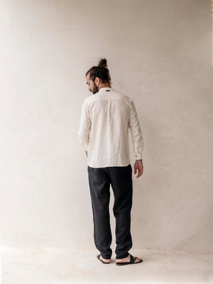 Back view of relaxed fit men's linen pants with an elastic waistband.