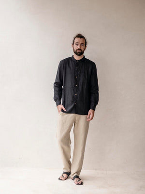 man wearing a linen outfit with classic pants and black shirt