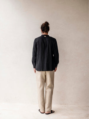 Back view of relaxed fit men's linen pants with an elastic waistband.